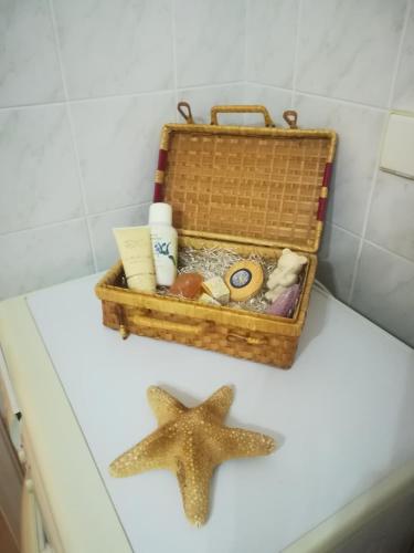 a basket with treasures and a starfish on a table at Quiet spacious apartment in Nafplio in Nafplio