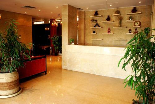 a lobby with potted plants and a counter in a store at Philae Hotel Aswan in Aswan