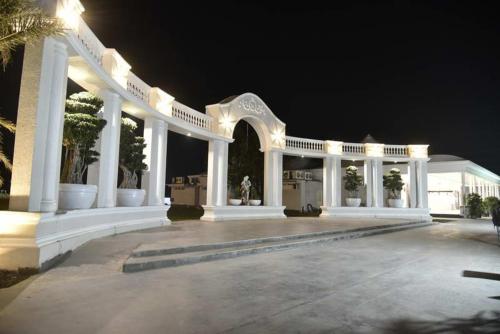 a large white pavilion with lights at night at Pride Hotel & Convention Centre Indore in Indore