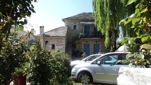 a silver car parked in front of a house at Hotel Ladias in Monodendri