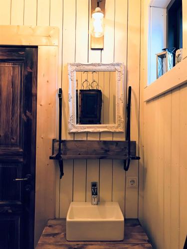 a bathroom with a sink and a mirror on the wall at Akurgerði Guesthouse 4 - Country Life Style in Ölfus