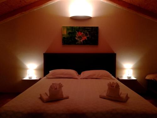 a bedroom with a bed with two hats on it at Holiday Home Old Barn in Umag