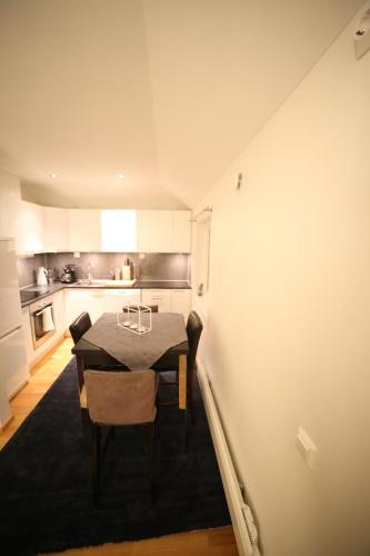 uma sala de jantar com uma mesa e uma cozinha em BraMy Apartments The Bucks Villa em Tromsø