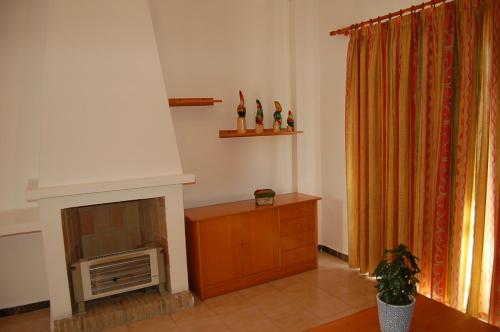 a living room with a fireplace and a television at Rinconada Real Bungalows- Ap2000 in Benidorm
