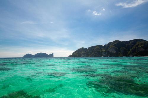 a view of the ocean with islands in the background at The Cove Phi Phi in Phi Phi Don