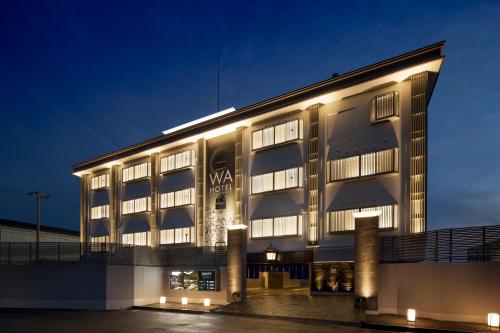 a building with lights on it at night at WA HOTEL TIMELESS RESORT - Adult Only in Wakayama