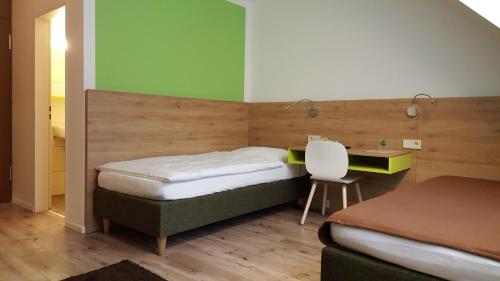 1 dormitorio con 2 camas, escritorio y silla en Gästehaus Ruh - Non-Smoking, en Freiburg im Breisgau