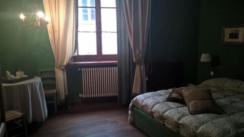 a bedroom with a bed and a window and a table at Grancia dei Celestini in Sulmona