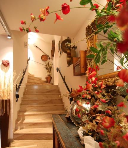a staircase in a room with flowers on the wall at Aparthotel Krösbacher in Fulpmes