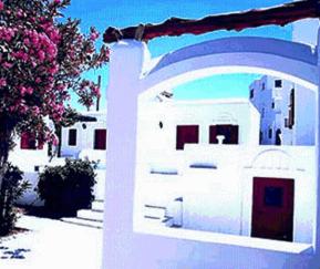a white and blue house with a blue wall at Villa Vasilis in Mikonos