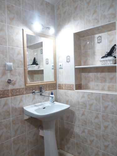 a bathroom with a sink and a mirror at Apartamenty MARINE in Świnoujście