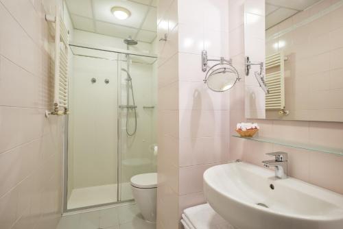 a bathroom with a sink and a toilet and a shower at Hotel Garibaldi in Mestre