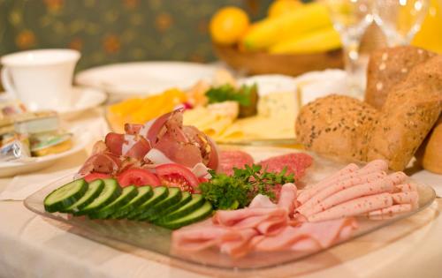 a plate of meat and vegetables on a table at Aparthotel Krösbacher in Fulpmes