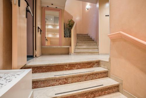 a hallway with stairs with a door and a staircase at Hotel Garibaldi in Mestre