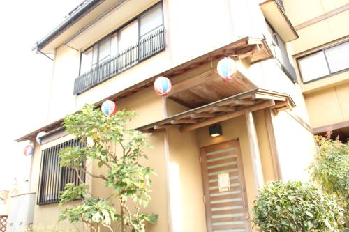 a building with balloons on the front of it at Okinawa Minshuku Kariyushi in Shirahama