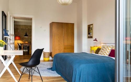 a bedroom with a bed and a desk and a chair at Brilliant Apartments in Berlin