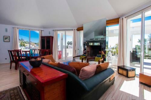a living room with a couch and a table at Villa Capricho in Marbella