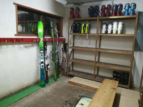 a room with skis and snowboards on a wall at Fujio Pension Madarao Apartment Hotel & Restaurant in Iiyama