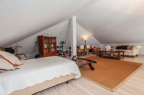 a bedroom with a bed and a living room at Villa Capricho in Marbella
