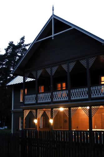 a large house with a fence in front of it at Apartamenti Strand in Saulkrasti