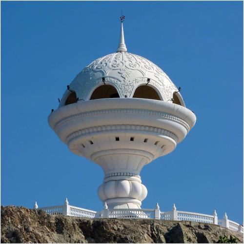 a white object with a dome on top of a building at Mutrah Hotel in Muscat