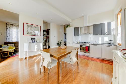 a kitchen and dining room with a wooden table and chairs at B&B Il Ramaiolo in Santa Maria a Monte