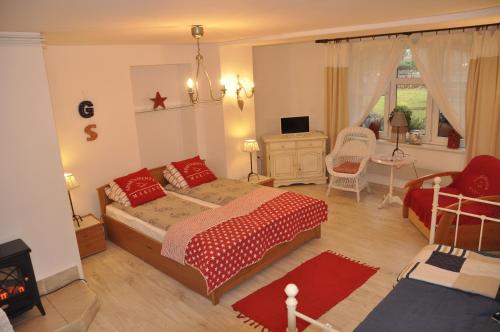 a bedroom with a bed and a living room at Apartamenty MARINE in Świnoujście