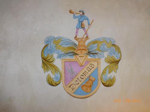a drawing of a man with a telescope on a crest at Hotel San Giovanni in Vigo di Fassa