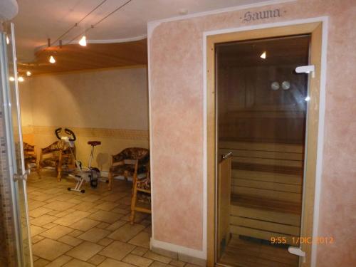 a door leading to a dining room with a table and chairs at Hotel San Giovanni in Vigo di Fassa