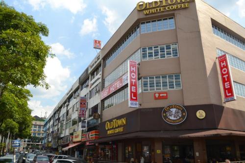 a building with signs on the side of a street at Eazy Hotel at Ampang in Batu Empat