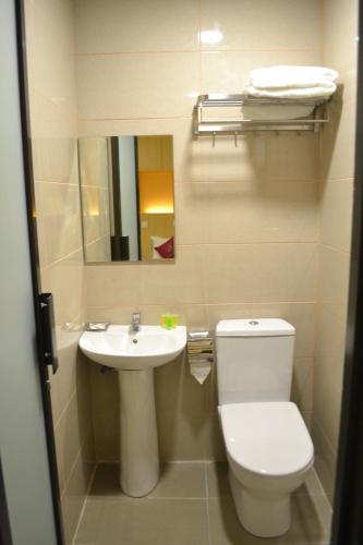 a bathroom with a toilet and a sink at Eazy Hotel at Ampang in Batu Empat
