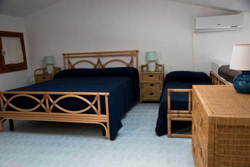 a bedroom with two beds and two night stands at Casa Valery Wonderful Sea View in Porto Rotondo