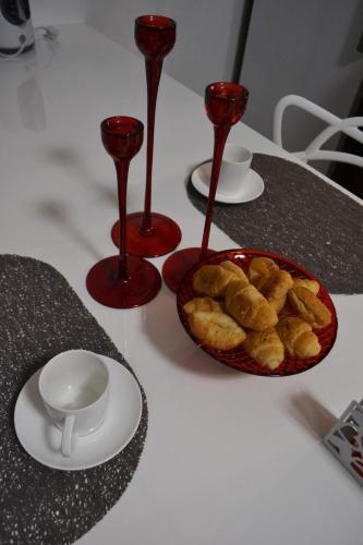 a table with two cups and a bowl of food at Apartment Fine Living 122 in Vršac