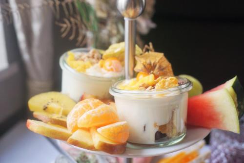 two jars of food with fruit on a plate at Pharos zur Seeve in Seevetal