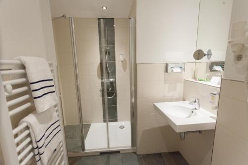 a bathroom with a shower and a sink at martas Hotel Allegra Berlin in Berlin