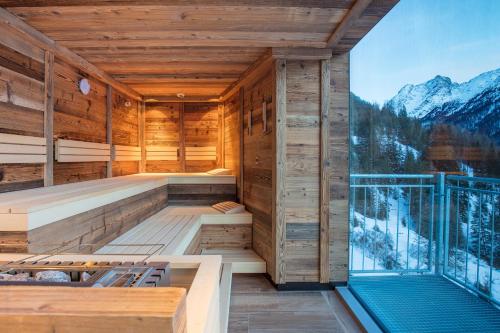an indoor sauna with a view of the mountains at Pension Winnebach in Längenfeld