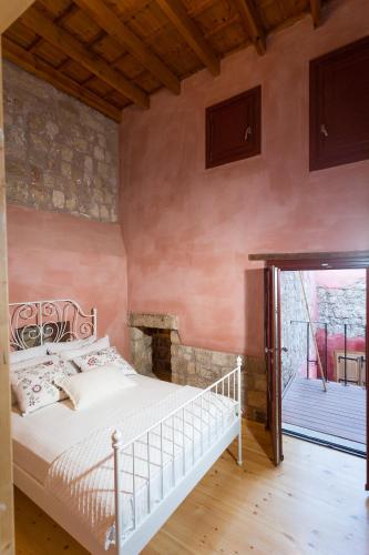 a bedroom with a white bed and a balcony at Rodi in Rhodes Town