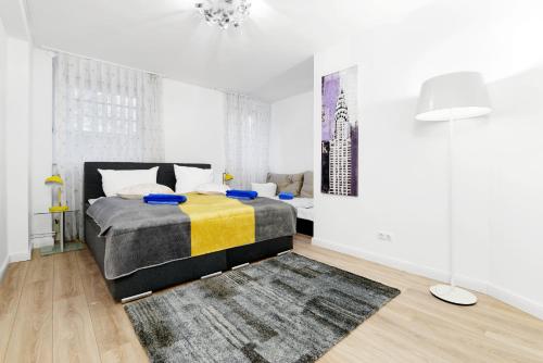 a white bedroom with a bed and a rug at BIG Central City Apt. Potsdamer Platz in Berlin