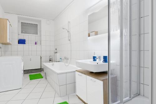 a white bathroom with a sink and a shower at BIG Central City Apt. Potsdamer Platz in Berlin
