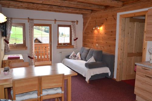 a living room with a couch and a table at Holdhof in Schladming