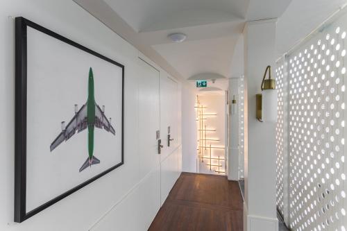 a hallway with a picture of a plane on the wall at Room Mate Emir, Istanbul in Istanbul