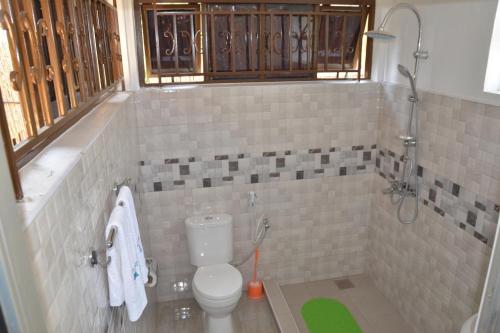 a bathroom with a toilet and a shower at Sheevy"s Bed N Breakfast in Fort Portal