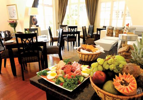 a table topped with baskets of fruits and vegetables at Sica's Guest House Musgrave in Durban