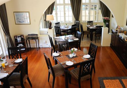 a restaurant with tables and chairs in a room at Sica's Guest House Musgrave in Durban