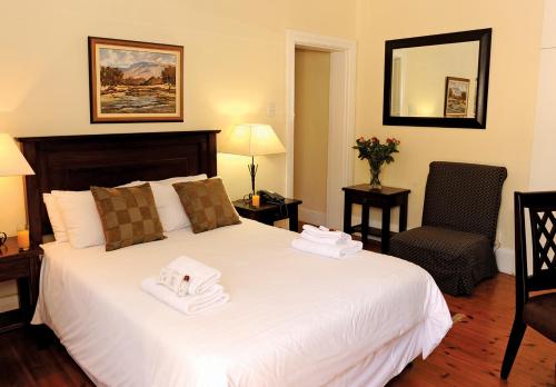 um quarto de hotel com uma cama com toalhas em Sica's Guest House Musgrave em Durban