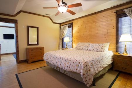 a bedroom with a bed and a ceiling fan at Swamp Rabbit Inn Travelers Rest in Travelers Rest