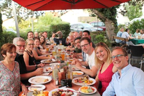 a group of people sitting at a table eating food at Hotel Berkheimer Hof in Esslingen