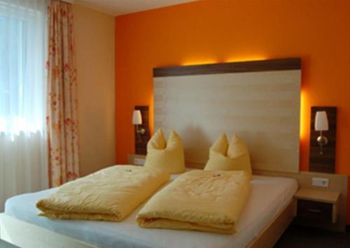 a bedroom with a bed with two pillows on it at Apart Vita Nova in Ischgl