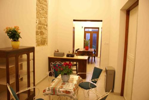 a room with a table and chairs and a dining room at Yiayia's House Limassol city in Limassol