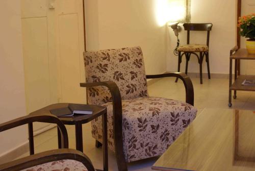a living room with a chair and a table at Yiayia's House Limassol city in Limassol